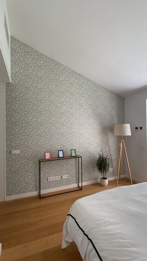 Pared de dormitorio con papel pintado de hojas ya instalado